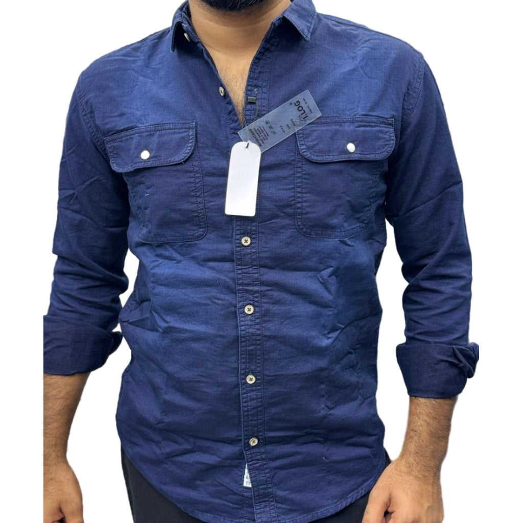 Navy blue shirt with a tag on a blurred background