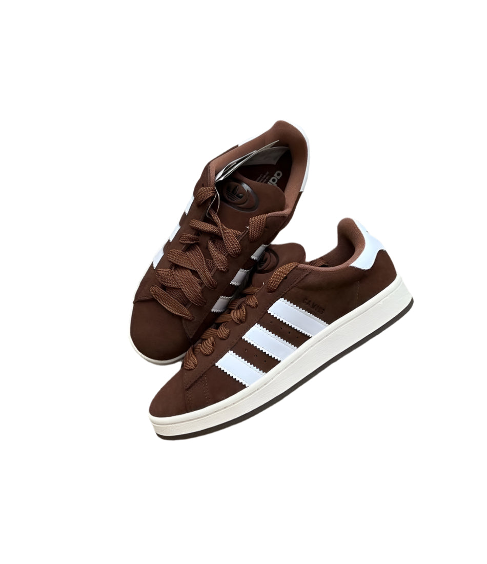 Brown Adidas sneakers with white stripes on a white background